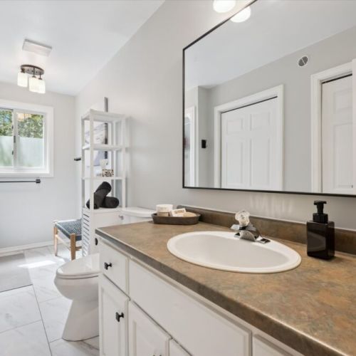 Clean and spacious bathroom with modern finishes and plenty of room for guests to refresh and recharge.