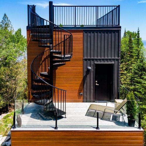 Relax on the elevated deck tucked into the treetops, then follow the spiral staircase to the rooftop terrace—multiple outdoor spaces designed for connection, quiet, and fresh Peninsula air.