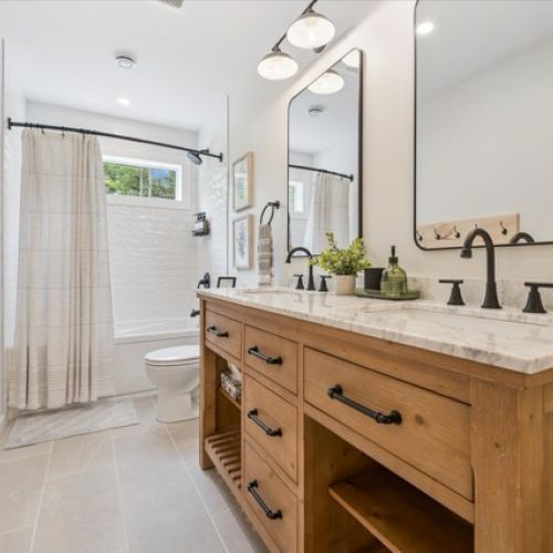 Featuring a double vanity, modern fixtures, and bright natural light for a refreshing start or end to your day.