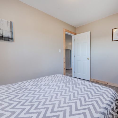 A calm and welcoming space, this bedroom is decorated with light colors and rustic furniture, making it feel like home.