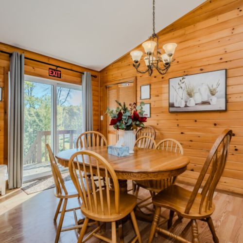 The dining area provides a perfect setting for family meals, with natural light streaming through the large patio door.