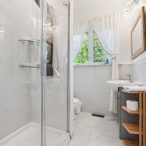 Clean, modern bathroom with walk-in shower and fresh finishes