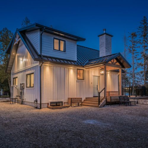 Peaceful lakeside cottage retreat with outdoor seating, modern design, and forest views. Perfect vacation rental for stargazing, family getaways, or cozy escapes in nature—Surrounded by tranquility.