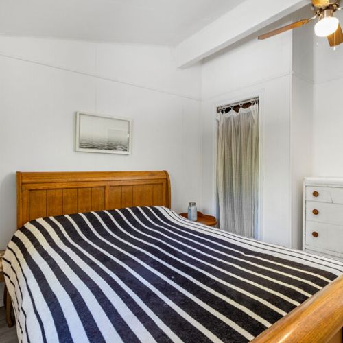 Cozy second bedroom offers a comfortable queen bed for restful nights after exploring the Peninsula.