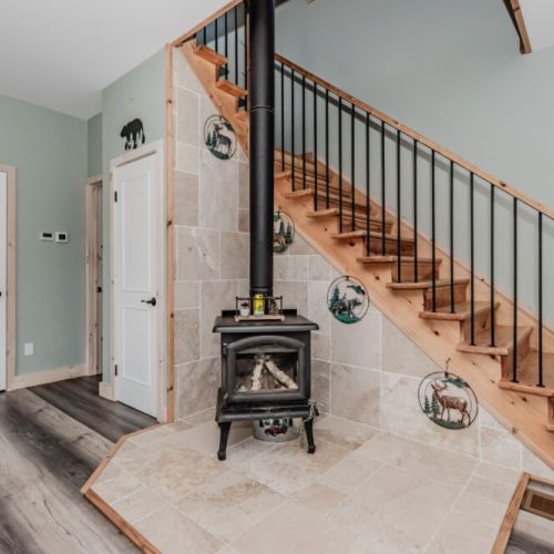 Gather around a cozy wood-burning stove in this charming cottage interior—perfect for chilly evenings after a day of adventure.