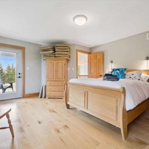 Bedroom 1: Bright and spacious bedroom with natural light and private outdoor access.