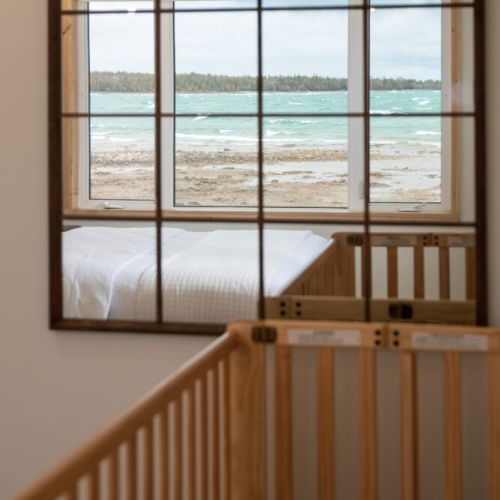 Family-Friendly with a View: This bedroom is designed with families in mind. The crib is perfectly positioned to offer your little one a front-row seat to the stunning lake views.