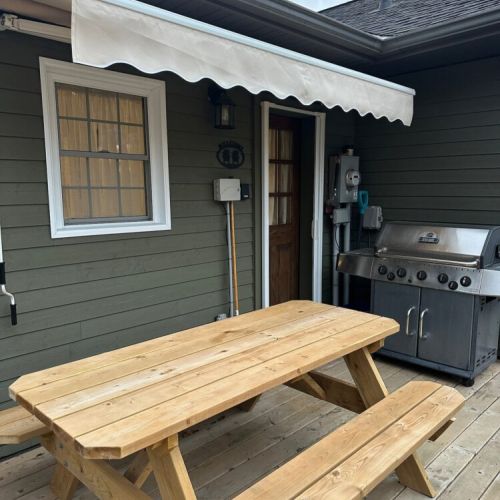 A full tank (propane) BBQ and picnic table for 6, conveniently located just outside the kitchen door. Covered awning for those rainy days (waterproof).