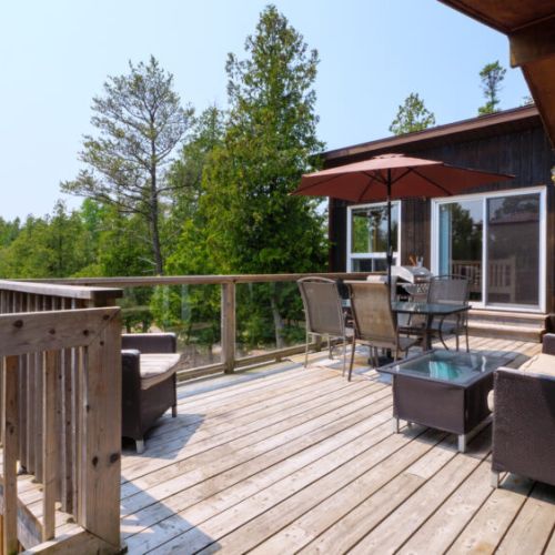 The back deck is large and features comfy patio loungers and an outdoor dining space.