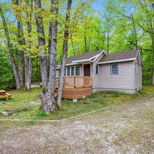 The charming guest cabin provides additional sleeping quarters or a quiet retreat with all the rustic comforts of cottage life.