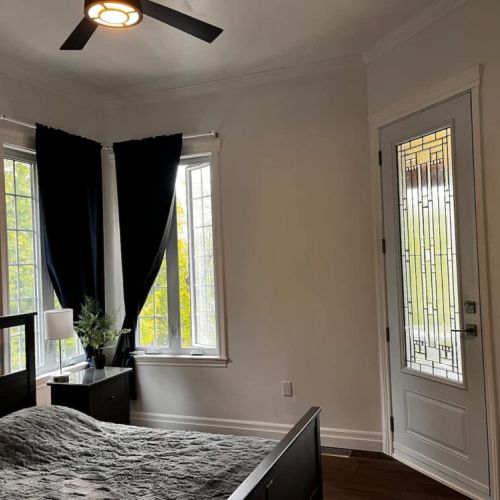 Bright bedroom with queen bed and convenient access to the outdoors