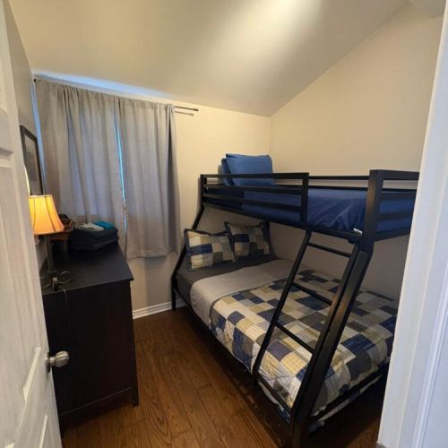 A bright bunk bedroom designed for kids or groups. A practical, comfortable space perfect for family vacations and relaxed cottage travel.