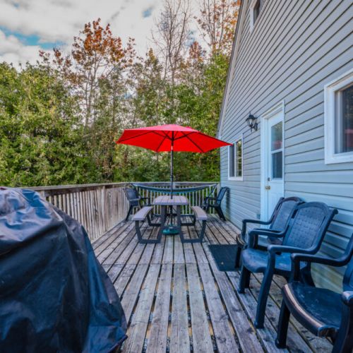 The deck includes ample seating, perfect for enjoying meals or unwinding in the fresh air.