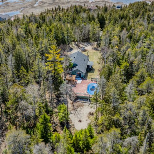 Spacious backyard with large deck, hot tub, and fire pit—perfect for relaxing evenings under the stars.