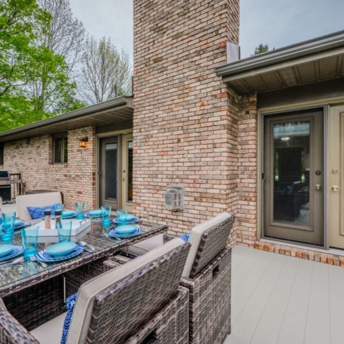 Enjoy al fresco dining on the elevated deck with a stylish table set and serene woodland views—ideal for sunny brunches or evening meals.