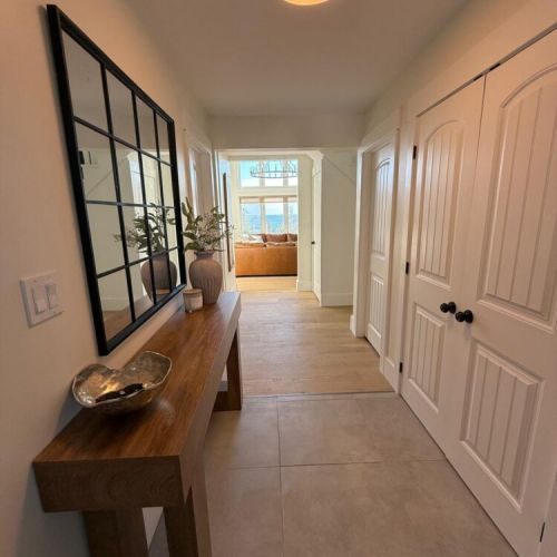Enter a calming space with stylish finishes, warm lighting, and a glimpse of the lake beyond—a perfect start to your retreat.