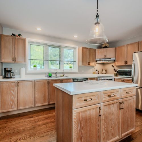Prepare meals in the spacious and well-appointed kitchen, featuring stainless steel appliances, oak cabinets, and a center island. Enjoy the comfort of a homey yet modern kitchen, perfect for hosting after a day exploring the Bruce Peninsula or kayaking on Georgian Bay.