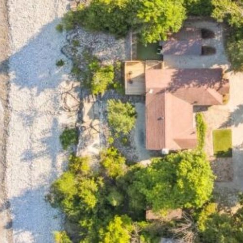 An overhead view of Cedar & Stone, showing its private shoreline, deck, and tucked-away location along peaceful Dyers Bay.