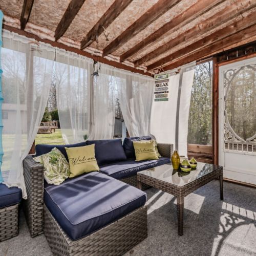 Relax on the spacious screened-in porch with comfy seating and garden views—your perfect spot for morning coffee or evening wine.