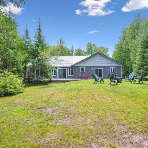 The spacious backyard offers plenty of room to relax, play, or gather around the fire pit with friends and family.