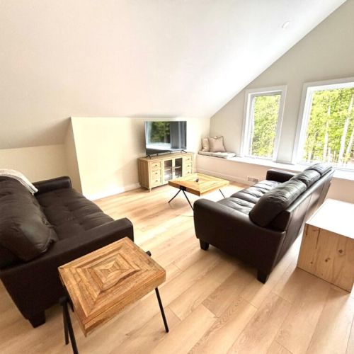 Another cozy hangout spot – plush seating, smart TV, and forest views make this lounge area a go-to for downtime and movie marathons.