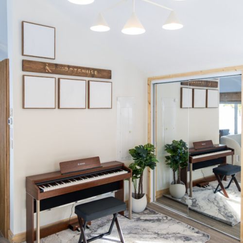 Entertain your family and friends with the professional digital piano in the foyer, creating a warm and inviting atmosphere alongside the fireplace and living area, all while enjoying breathtaking lake views.