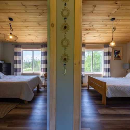 Spacious dual bedrooms with wood ceilings and scenic windows—perfect for families or friends traveling together on a Bruce Peninsula adventure.