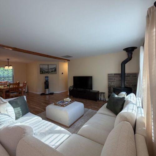 Enjoy cottage living at its finest with a bright, welcoming lounge, rustic wood accents, and a cozy fireplace atmosphere.