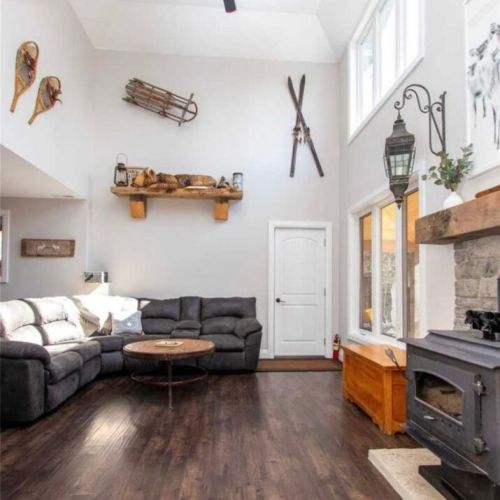Soaring ceilings, cozy woodstove, and inviting cottage living space.