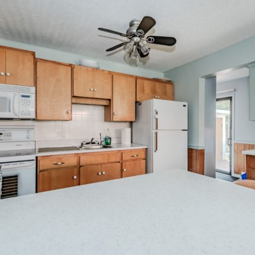 A closer look at the modern kitchen, complete with essential appliances and ample counter space. The coffee bar is a delightful addition, perfect for preparing your favorite brews.