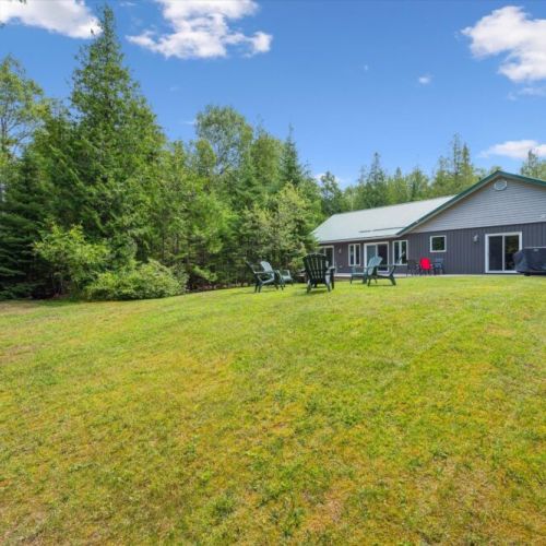 Spacious backyard lawn with seating around the fire pit—perfect for cozy evenings under the stars.