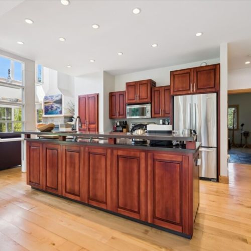 Modern chef’s kitchen with large island seating and open-concept design.