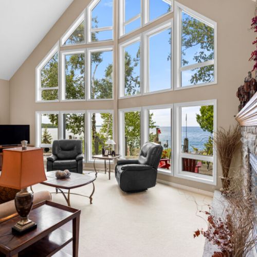 The view steals the show. Soaring floor-to-ceiling windows fill the great room with natural light while showcasing the beautiful waterfront beyond.