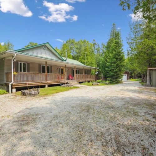 A wide front porch and easy driveway access welcome you to this peaceful Bruce Peninsula getaway.