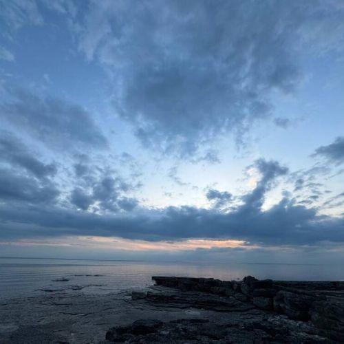 Enjoy peaceful evenings by the water with stunning views of Lake Huron's rocky shoreline and twilight skies—an unforgettable retreat for nature lovers and sunset seekers.