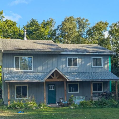 Larkwhistle Cottage – a cozy two-storey retreat surrounded by trees, offering a peaceful Bruce Peninsula getaway.