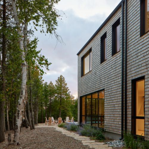 Evening ambiance along the cottage pathway, surrounded by lush greenery and natural beauty. Perfect for a quiet stroll or relaxing by the outdoor seating area.