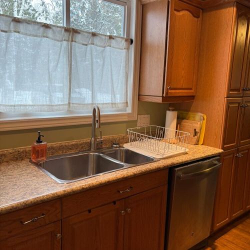 Large sink and prep area with a sunny window view to keep things bright and inviting.