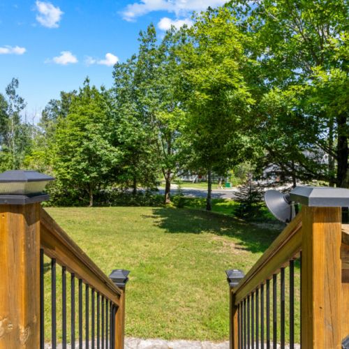 The spacious front yard offers plenty of room to relax and play.