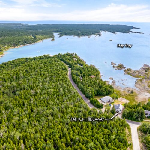 An aerial view highlights Fathom Hideaway's beautiful location on the sheltered shores of Hay Bay.