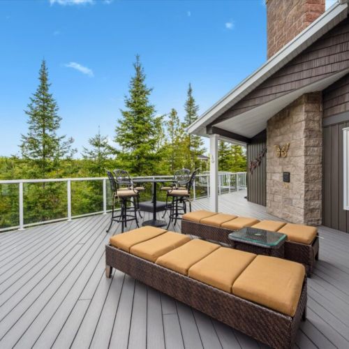 The oversized rear deck offers stunning elevated views, ideal for soaking up sun or enjoying meals alfresco. With chaise loungers and bar seating, it's built for leisure and laughter.