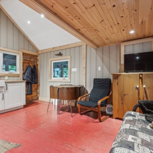The heart of the cabin offers everything you need: a smart TV for rainy nights, a fold-down table for meals or board games, and comfy seating to unwind after a day exploring Georgian Bay.