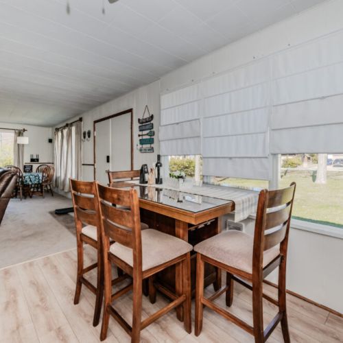 Bright dining nook with scenic views and natural light—perfect for enjoying morning coffee, casual meals, or planning your next day of lake adventures during your relaxing cottage stay.