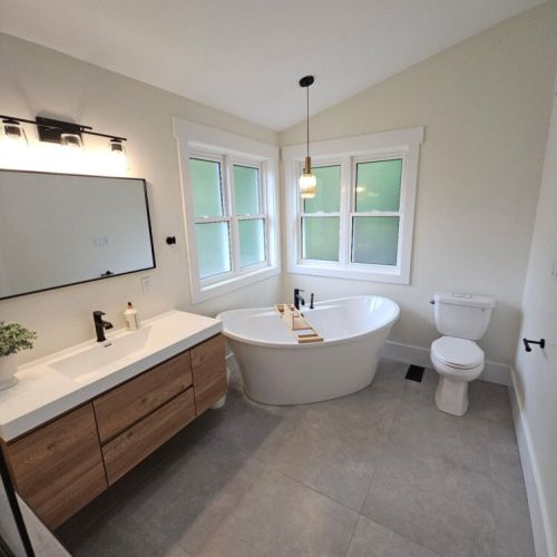 A spa-style retreat featuring a deep soaker tub, clean modern finishes, and tranquil forest views for total relaxation.