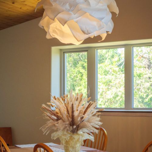 The dining area provides a welcoming space to gather for meals beneath beautiful vaulted cedar ceilings.