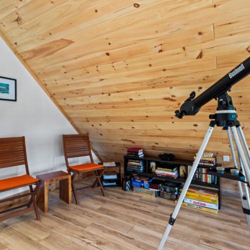 The loft offers books, board games, and a telescope for relaxing evenings indoors.