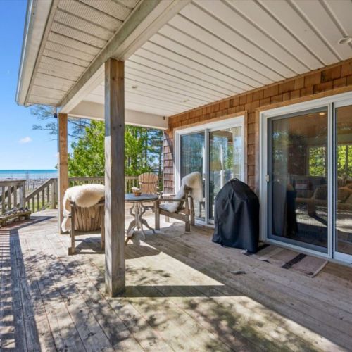 Enjoy outdoor living on the spacious covered deck, complete with BBQ, comfortable seating, and beautiful lake views in any weather.