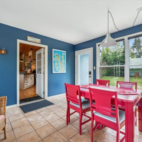 Panoramic windows in the sunroom bring in peaceful views of both the water and the backyard.