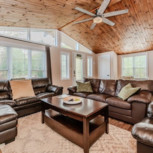 The blend of natural wood accents and modern furnishings give this living space a cozy, cabin-like feel with all the comforts of home.