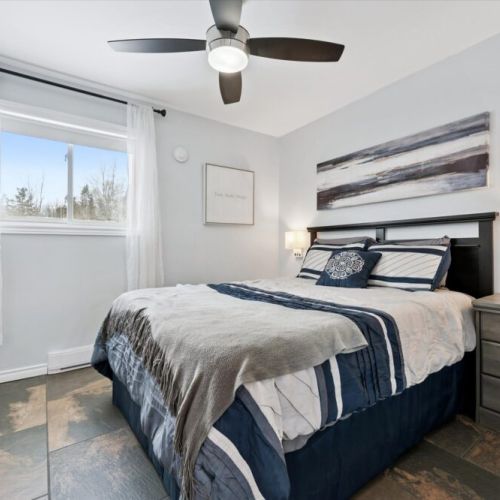 Calm, comfortable bedroom with cozy bedding and natural light — designed for a great night’s sleep.